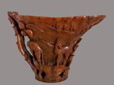 a wooden vase with carvings of birds and flowers on it