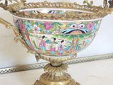 a gold vase with a floral design on it