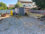a lot of junk in the back yard of a house