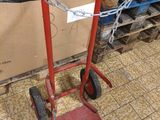 a red hand truck that is sitting on the floor