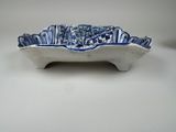 a blue and white bowl that is on a table