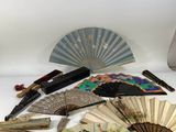 many different types of hand fans on the table