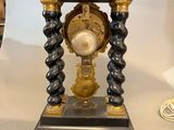 a black and gold clock sitting on a table