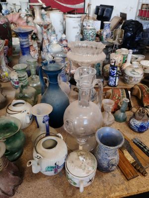 de nombreux vases et bols posés sur une table dans une pièce