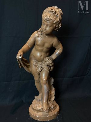 a statue of a boy sitting on top of a wooden base
