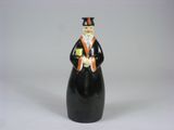 a figurine of a man wearing a top hat and holding a book