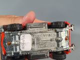 a person holding a toy car in their hand