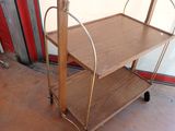 a wooden cart with two shelves on it in a garage