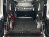 the back of a van with the doors open in a garage