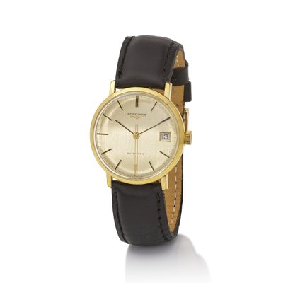 a gold plated wrist watch with black leather strap
