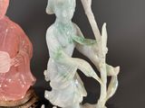 three figurines of a woman and a man sitting on a tree stump
