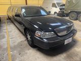 a black lincoln town car parked in a parking lot