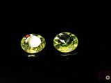 pair of green crystal stud earrings on black background