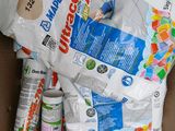 a bag of toilet paper, toilet paper, and other cleaning supplies