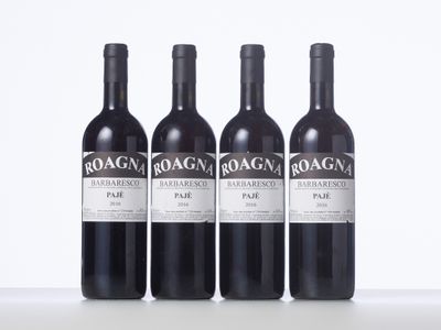 three bottles of red wine sitting on top of a white table