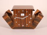 a wooden clock that is sitting on a table