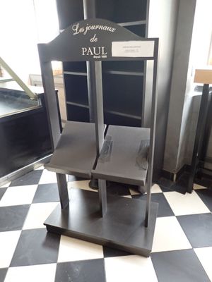 a black and white checkered floor with two chairs on it