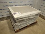 a stack of boxes on top of a pallet in front of a wall