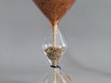 a hourglass with sand inside of it on a white surface