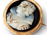 gold - plated brooch depicting a bust of a man in a black and white cameo