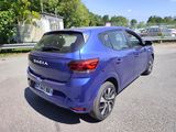 the rear end of a blue car parked on the side of the road