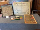a table with a table cloth covered with pictures and framed pictures