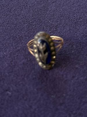 a close up of a silver ring with a blue stone in it