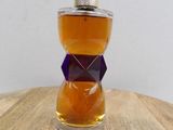 an image of a bottle of perfume on a wooden table