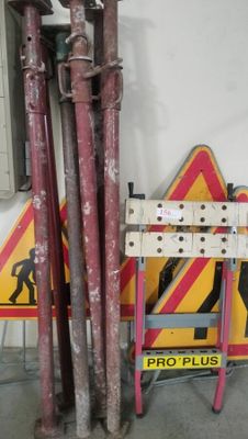 a red and yellow sign and some pipes in a room