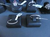 a lot of rings and bracelets on display on a table