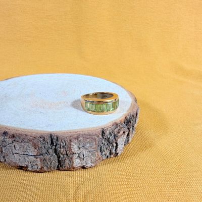 a ring sitting on top of a piece of wood