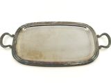 an old silver tray with handles and handles on a white surface