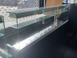 a glass display case in the middle of a room