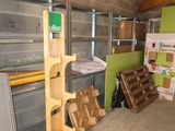 a pile of wood in a room with a green wall