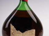 bottles of liquor on a white surface with a red cap