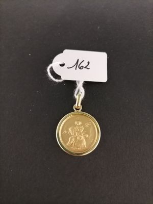 a close up of a gold coin with a tag on it