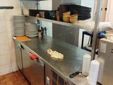 a kitchen with a lot of dishes on the counter