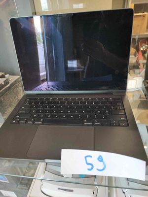 a laptop computer sitting on a glass table in a store