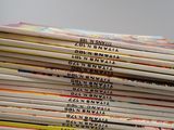 a lot of books that are stacked on top of each other