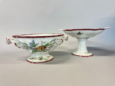 pair of porcelain bowls with floral designs on them on a white surface