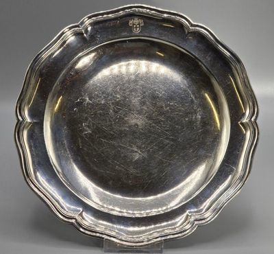 a silver plate with a flower design on the rim