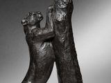 bronze sculpture of two dogs playing with each other on a marble base