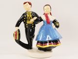 a figurine of a man and a woman holding hands