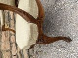 a close up of a chair with a cushion on it