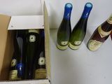 three bottles of wine sitting in a box on a table
