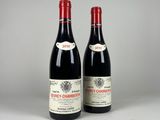 deux bouteilles de vin rouge posées l'une à côté de l'autre sur une table