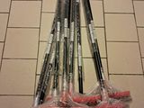 five different types of brooms on a tiled floor