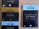 two boxes of masks are sitting on a table next to each other