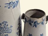 two blue and white vases sitting next to each other