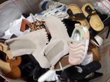 a bucket full of shoes and shoes that are in it